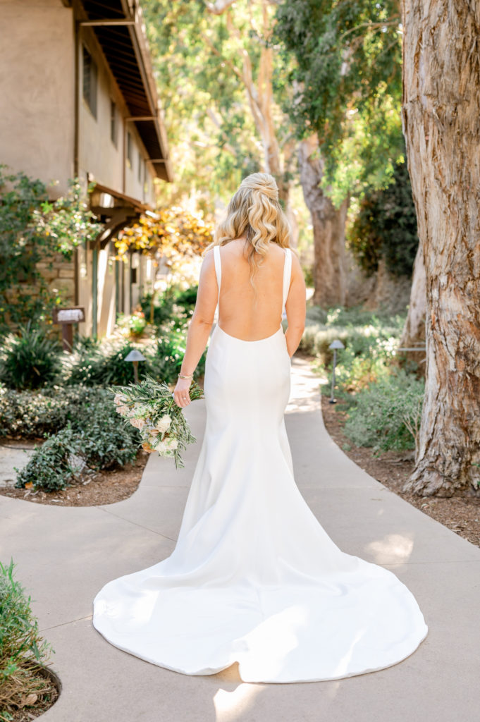 Bride with a low cut open back wedding dress