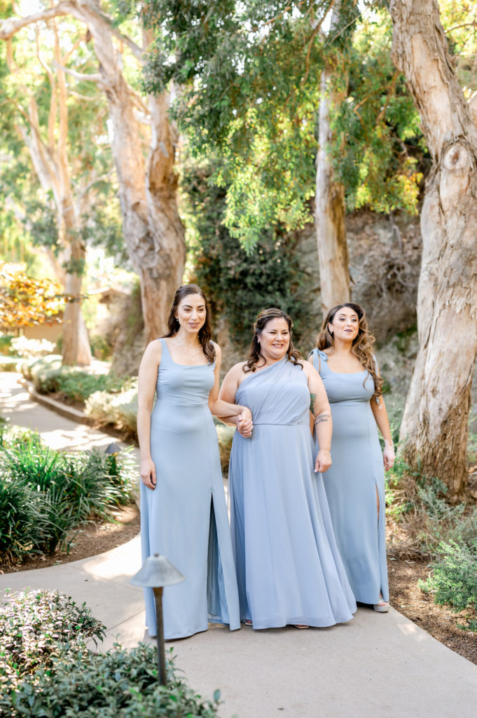 Bride's first look with bridesmaids. Bridesmaids are wearing long light blue dresses