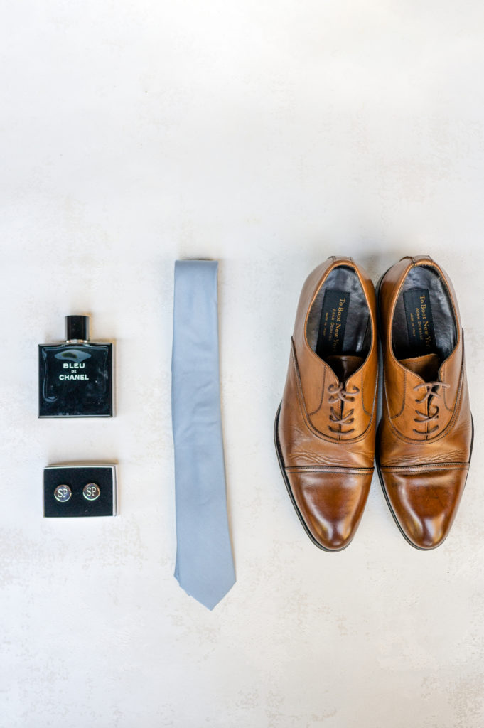 Groom's details. Shoes, custom cufflinks, blue tie and cologne 