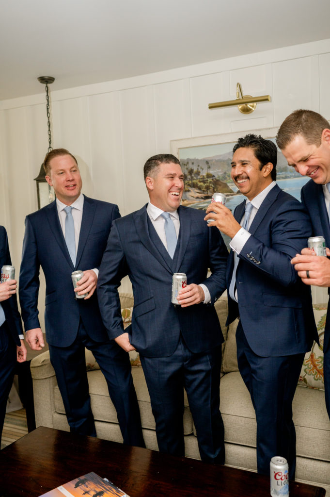 Groom sharing a beer with his groomsmen