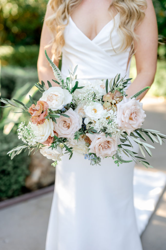 bride holding her whimsical floral bouquet 