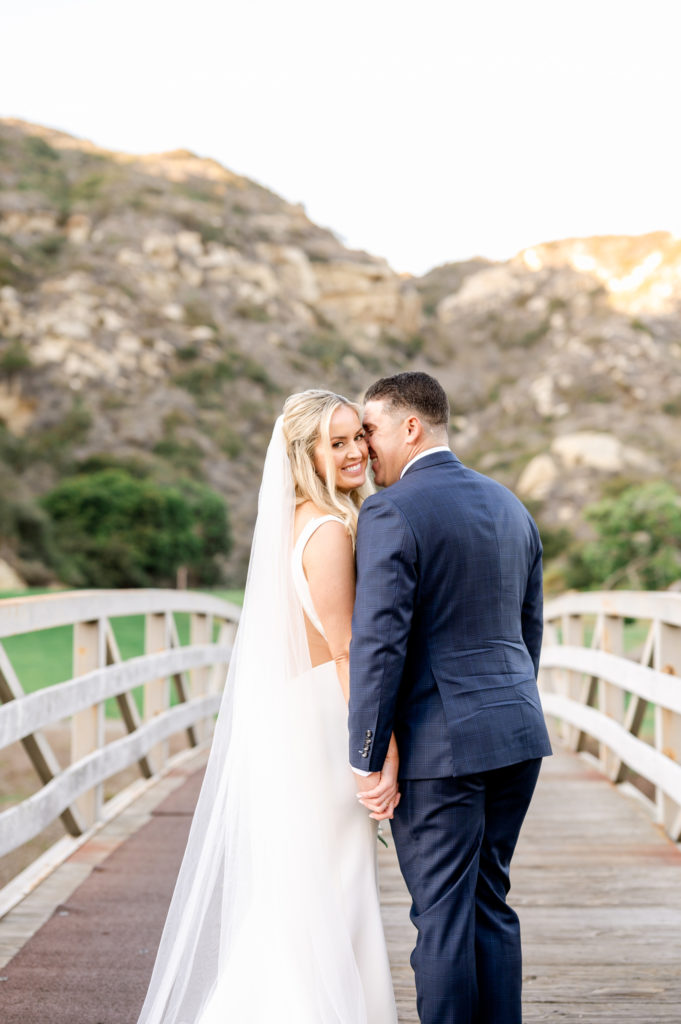 Bride and groom on a bridge at the Ranch in Laguna