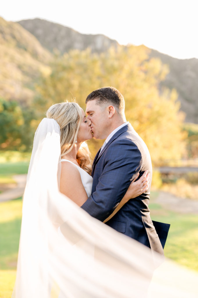 Bride and groom kissing with veil swooped in front at The Ranch Laguna Beach wedding