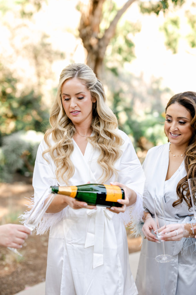 Bride pouring a glass of champagne, Veuve Clicquot 