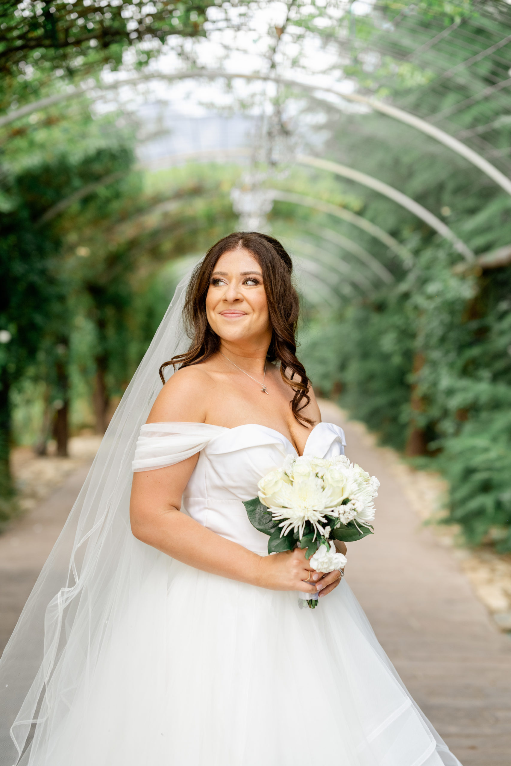 Bride holding flowers at garden