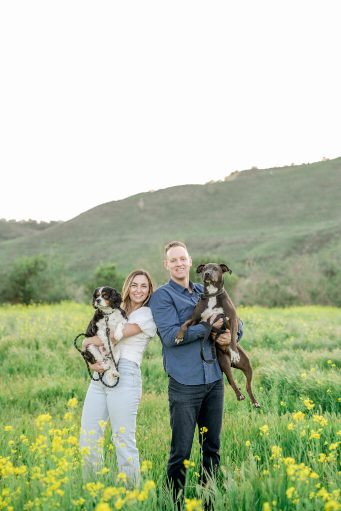 Couple with dogs at Flower Fields in San Juan Capistrano