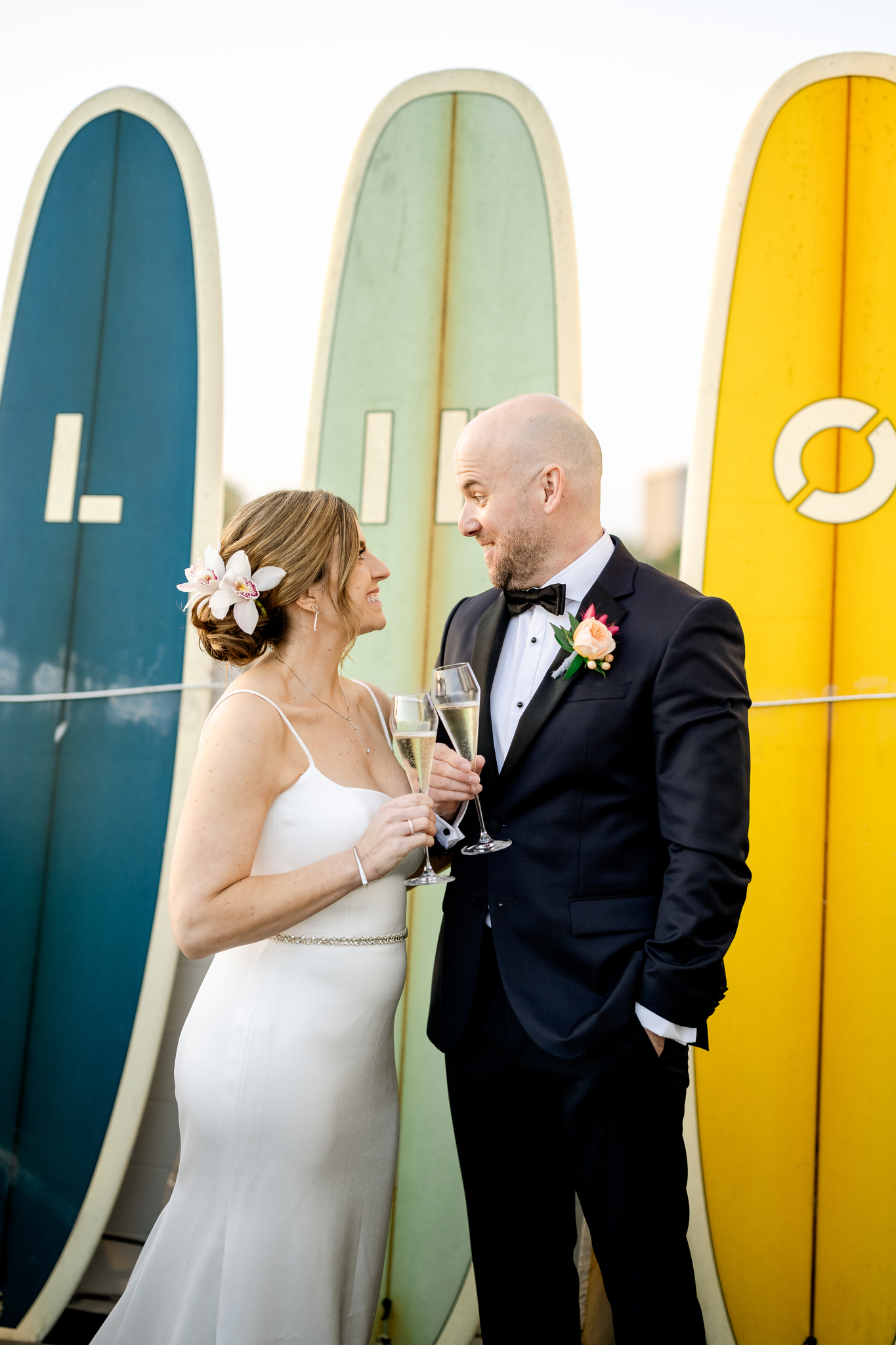 Lido House Wedding in newport beach bride and groom in front of surfboards